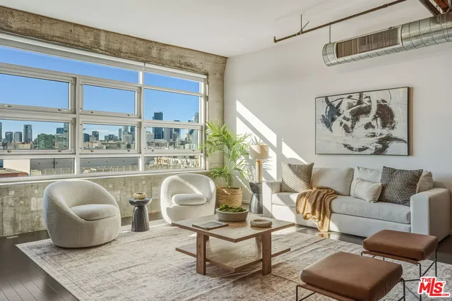a living room with furniture and a floor to ceiling window