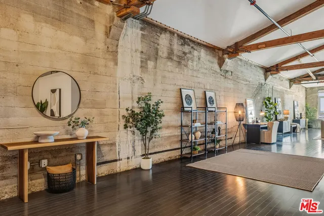 a room with lots of wooden furniture and windows