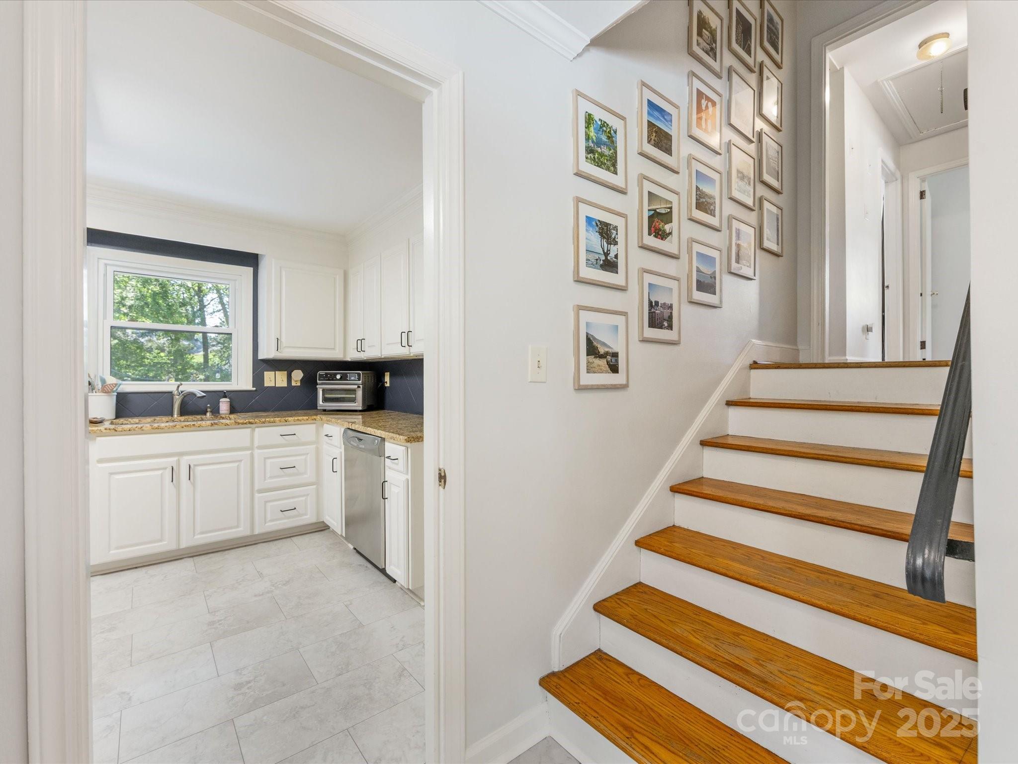 3200 Spring Valley Road Charlotte, NC 28210 - Photo 19 of 45 a kitchen with cabinets and white appliances