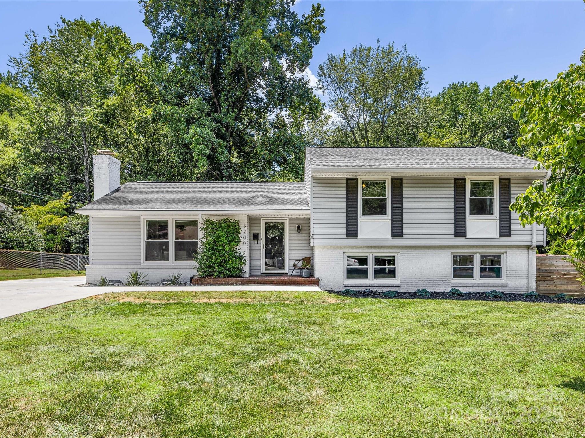 3200 Spring Valley Road Charlotte, NC 28210 - Photo 2 of 45 a front view of house with yard and green space