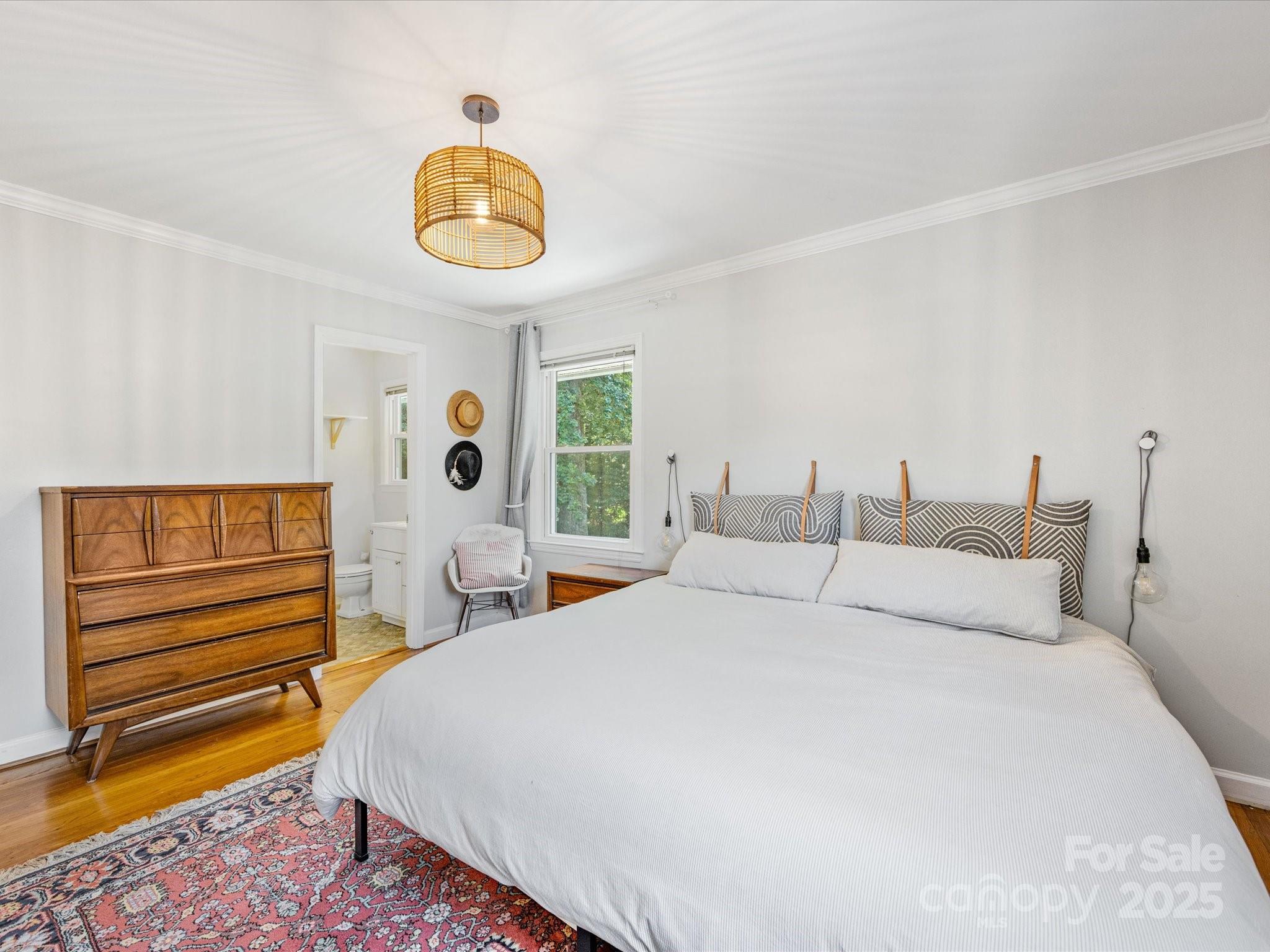 3200 Spring Valley Road Charlotte, NC 28210 - Photo 21 of 45 a bedroom with a bed and a chandelier