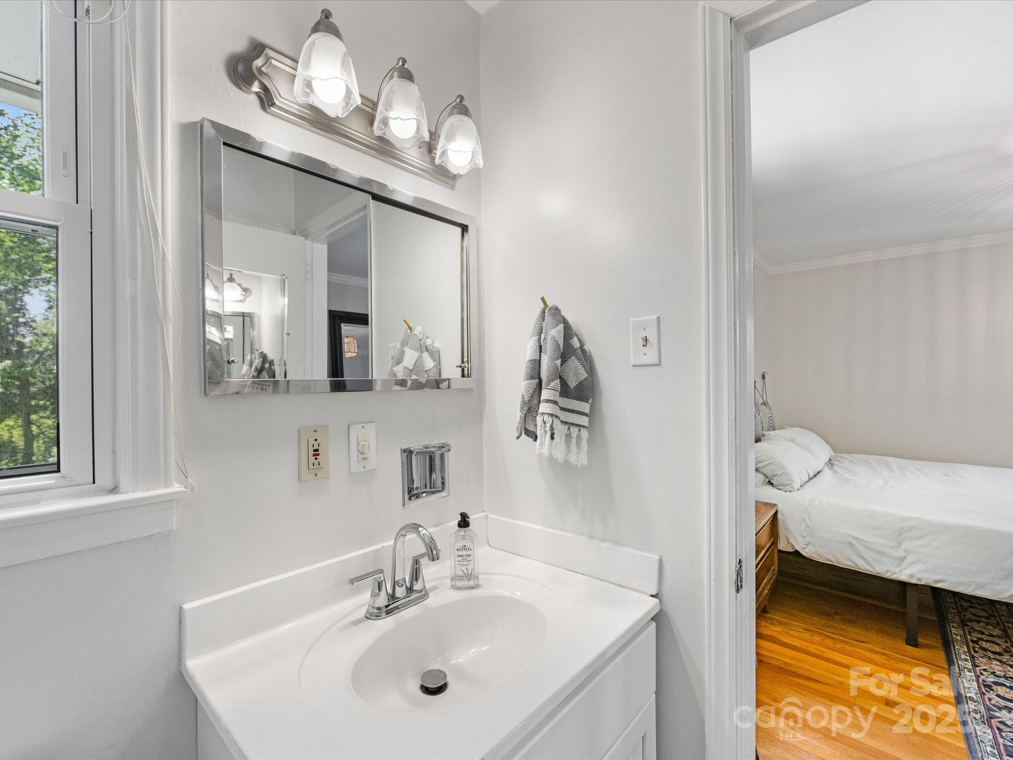 3200 Spring Valley Road Charlotte, NC 28210 - Photo 23 of 45 a en suite bathroom with a sink and a mirror