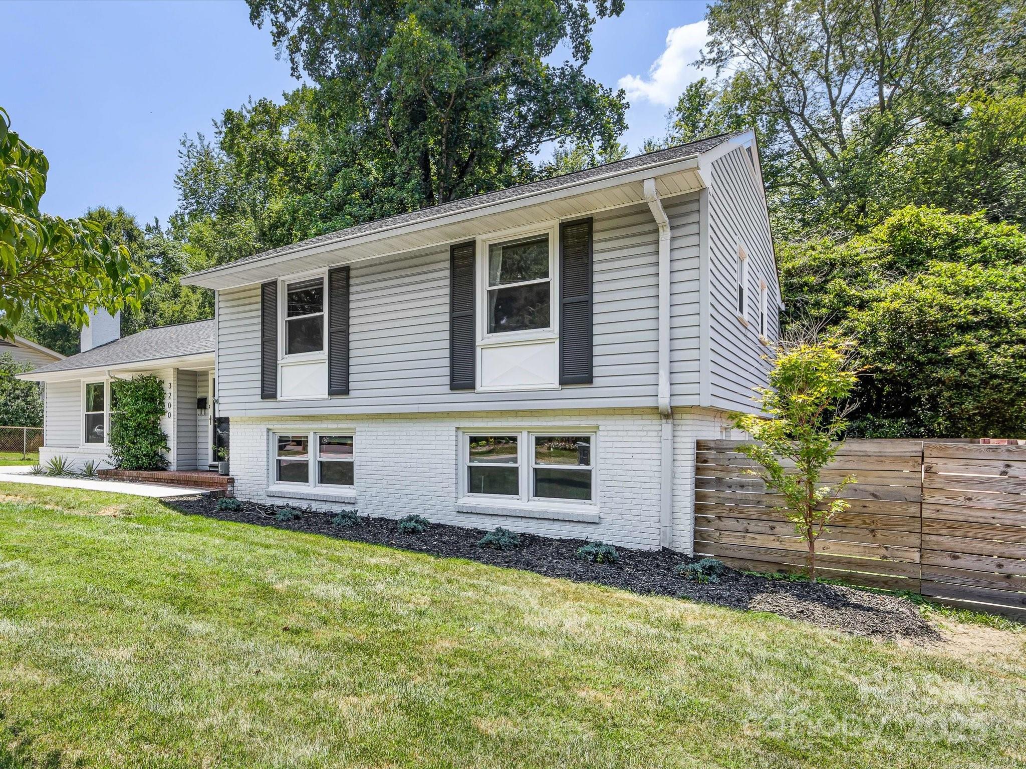 3200 Spring Valley Road Charlotte, NC 28210 - Photo 3 of 45 a front view of a house with a yard