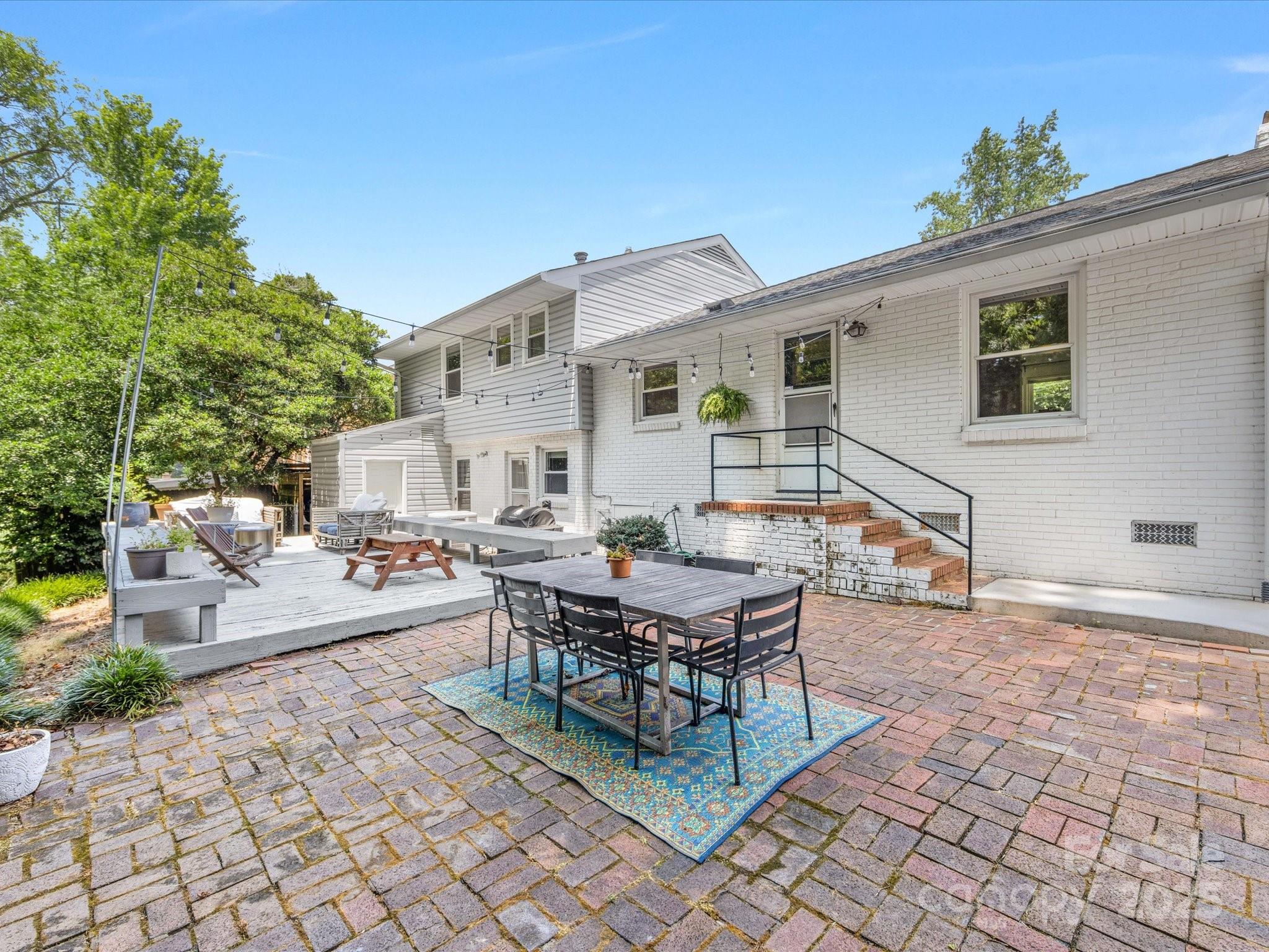 3200 Spring Valley Road Charlotte, NC 28210 - Photo 41 of 45 a view of a patio with table and chairs and potted plants