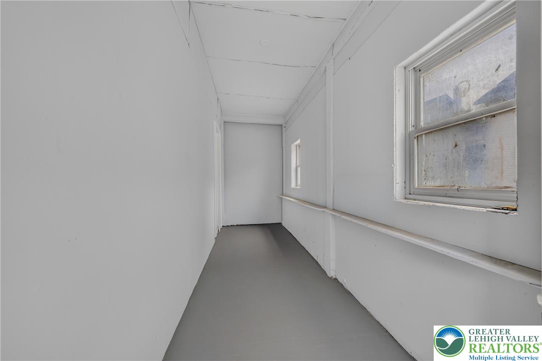 313 Main Street Slatington, PA 18080 - Photo 35 of 73 A utilitarian hallway with a window offering glimpses of the outdoors.