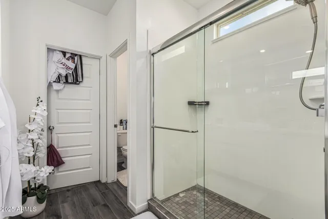 a view of walk in closet with clothes