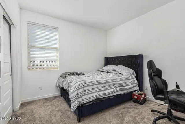 a bedroom with a bed and a closet