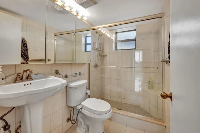 a bathroom with a sink toilet and shower