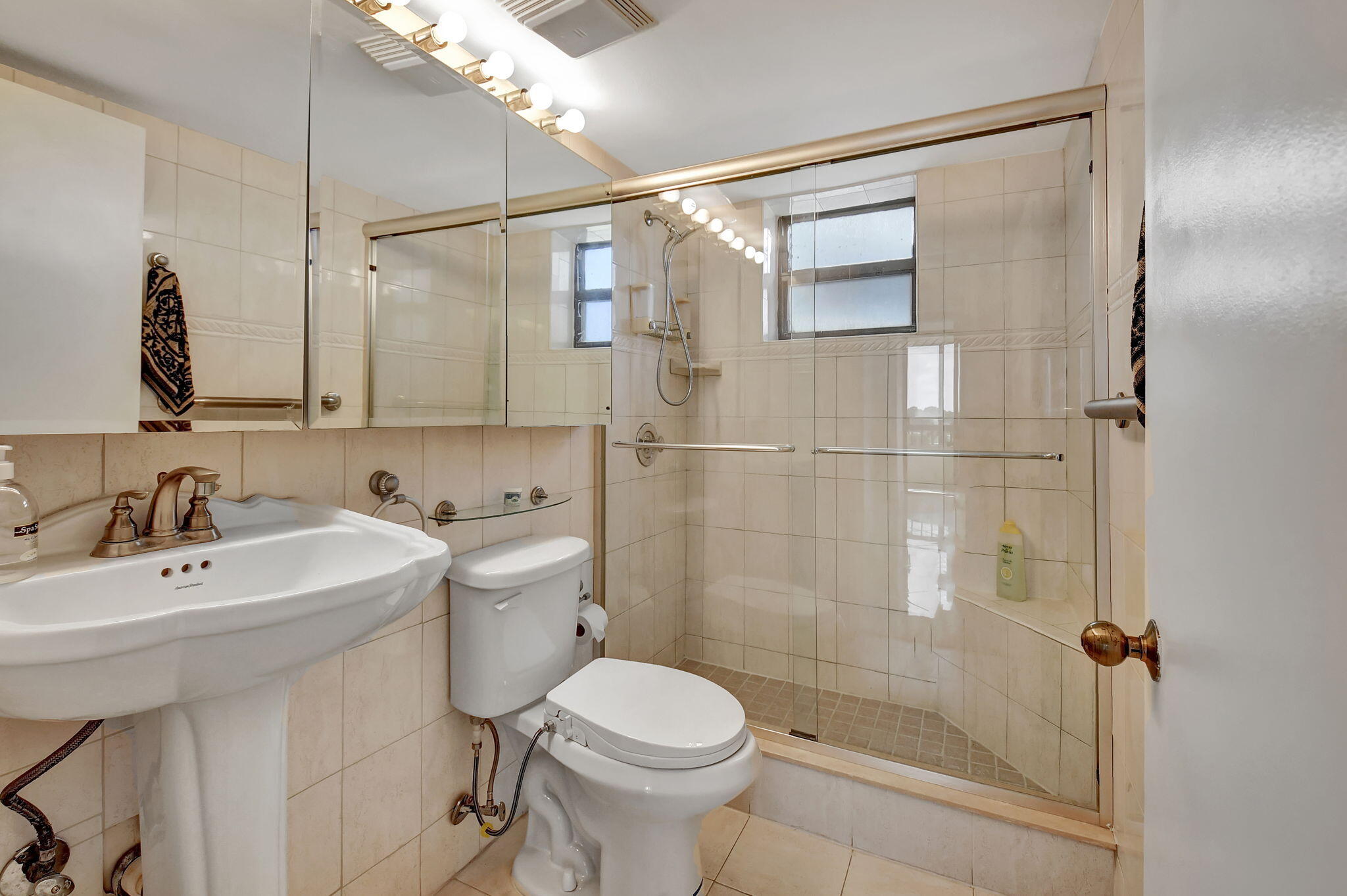 6372 La Costa Drive, Unit 302 Boca Raton, FL 33433 - Photo 24 of 52 a bathroom with a sink toilet and shower