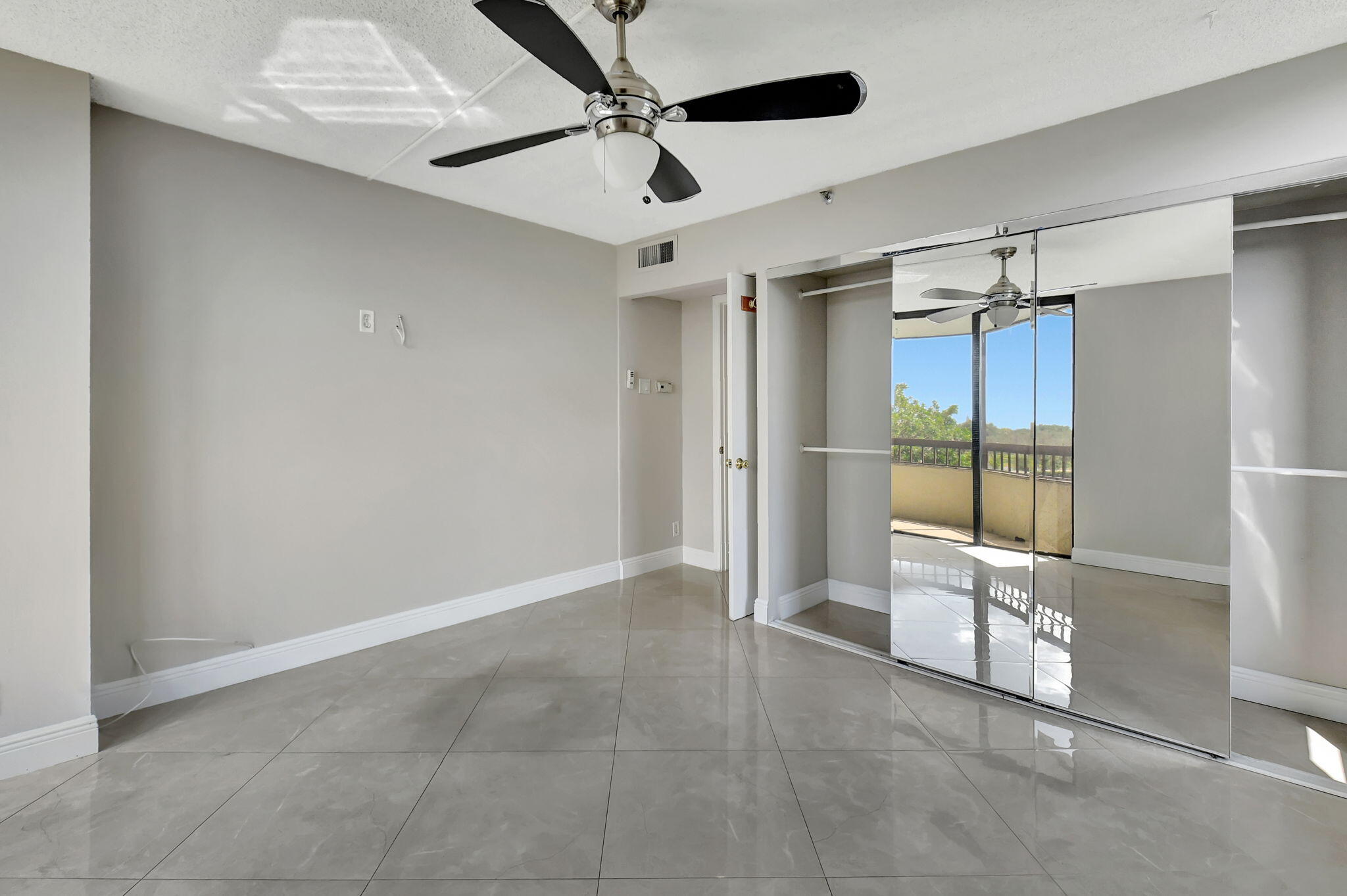 6372 La Costa Drive, Unit 302 Boca Raton, FL 33433 - Photo 28 of 52 a view of empty room with cabinet and ceiling fan