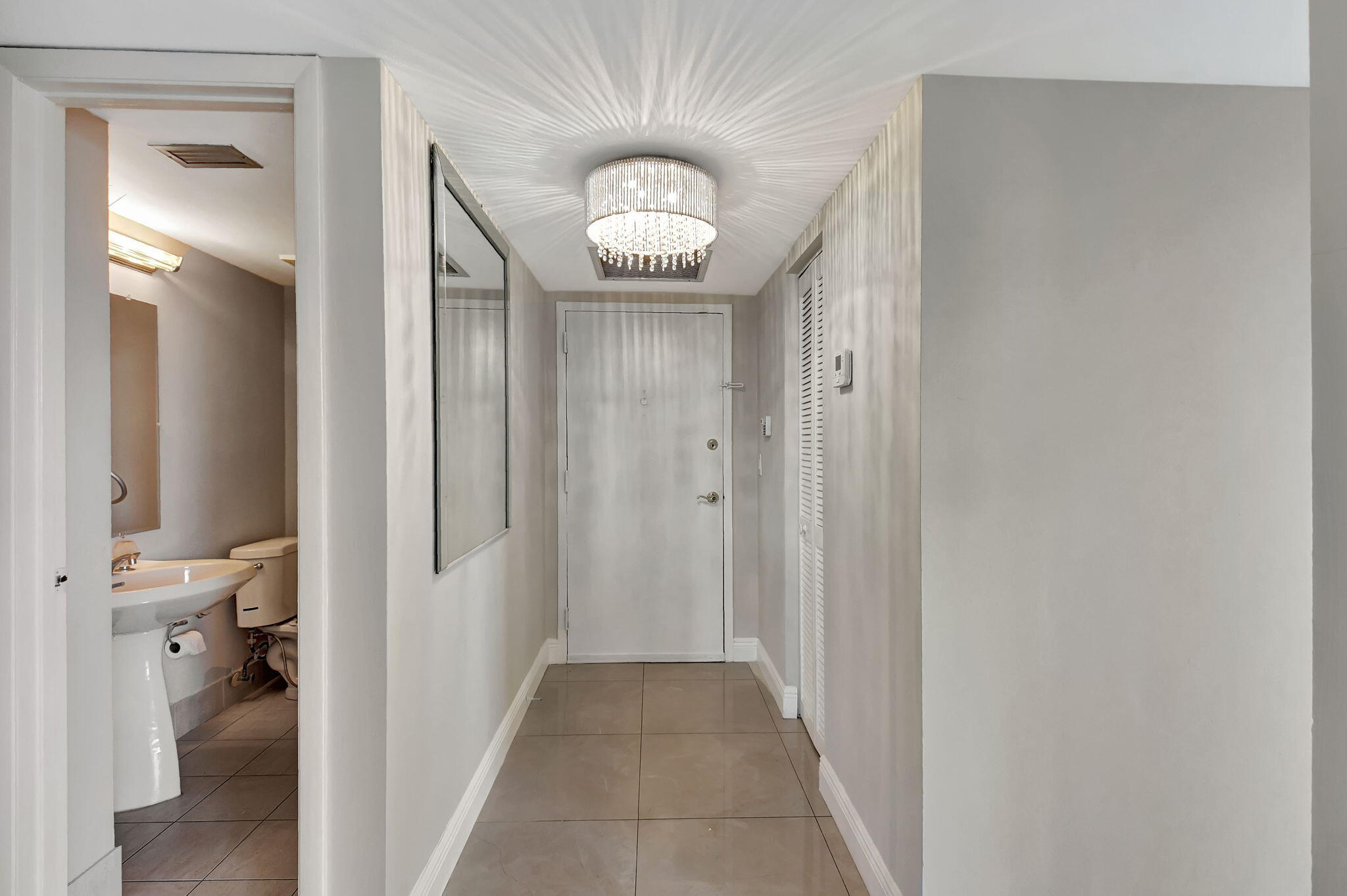 6372 La Costa Drive, Unit 302 Boca Raton, FL 33433 - Photo 3 of 52 a view of a hallway with a livingroom and a gallery