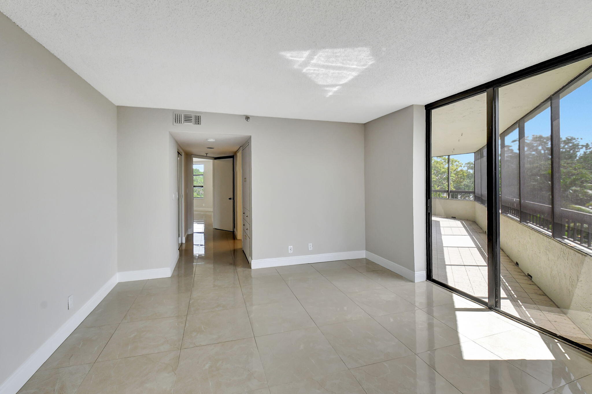 6372 La Costa Drive, Unit 302 Boca Raton, FL 33433 - Photo 32 of 52 wooden floor in an empty room with a window