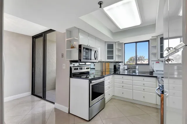 a kitchen with stainless steel appliances a stove sink and microwave