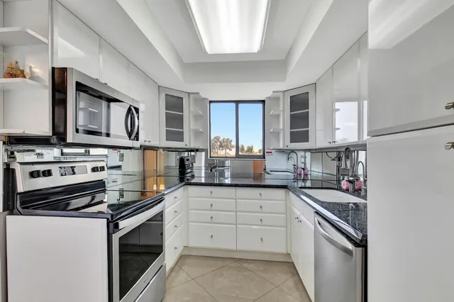 a kitchen with stainless steel appliances a stove microwave and cabinets
