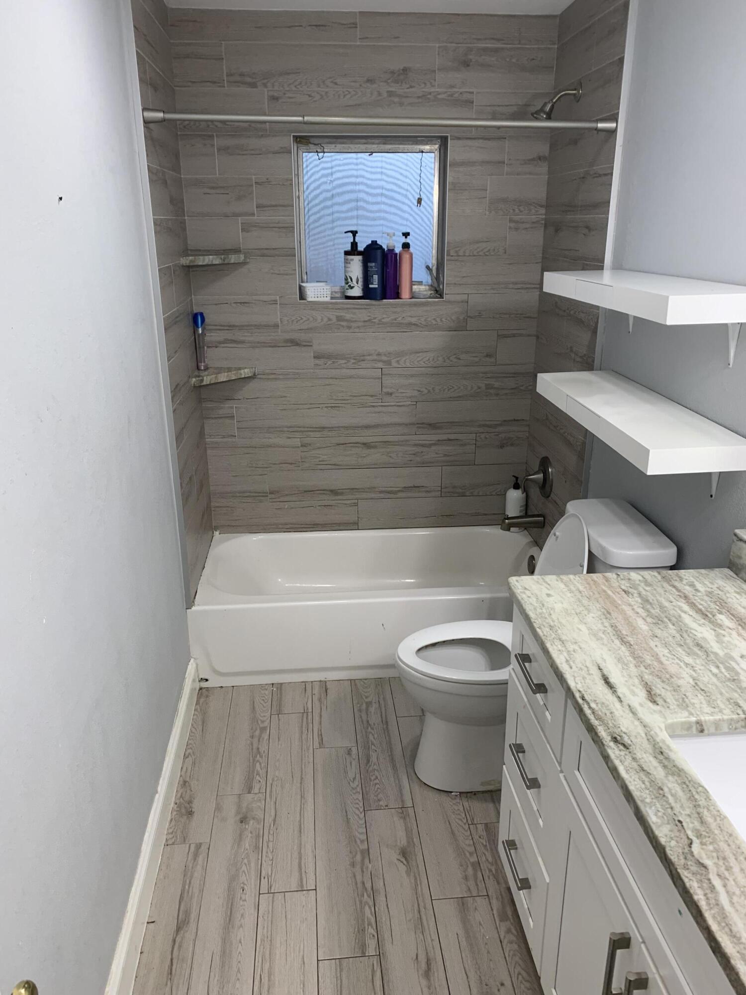 1156 Block Island Road Wellington, FL 33414 - Photo 15 of 15 a bathroom with a granite countertop toilet sink and mirror