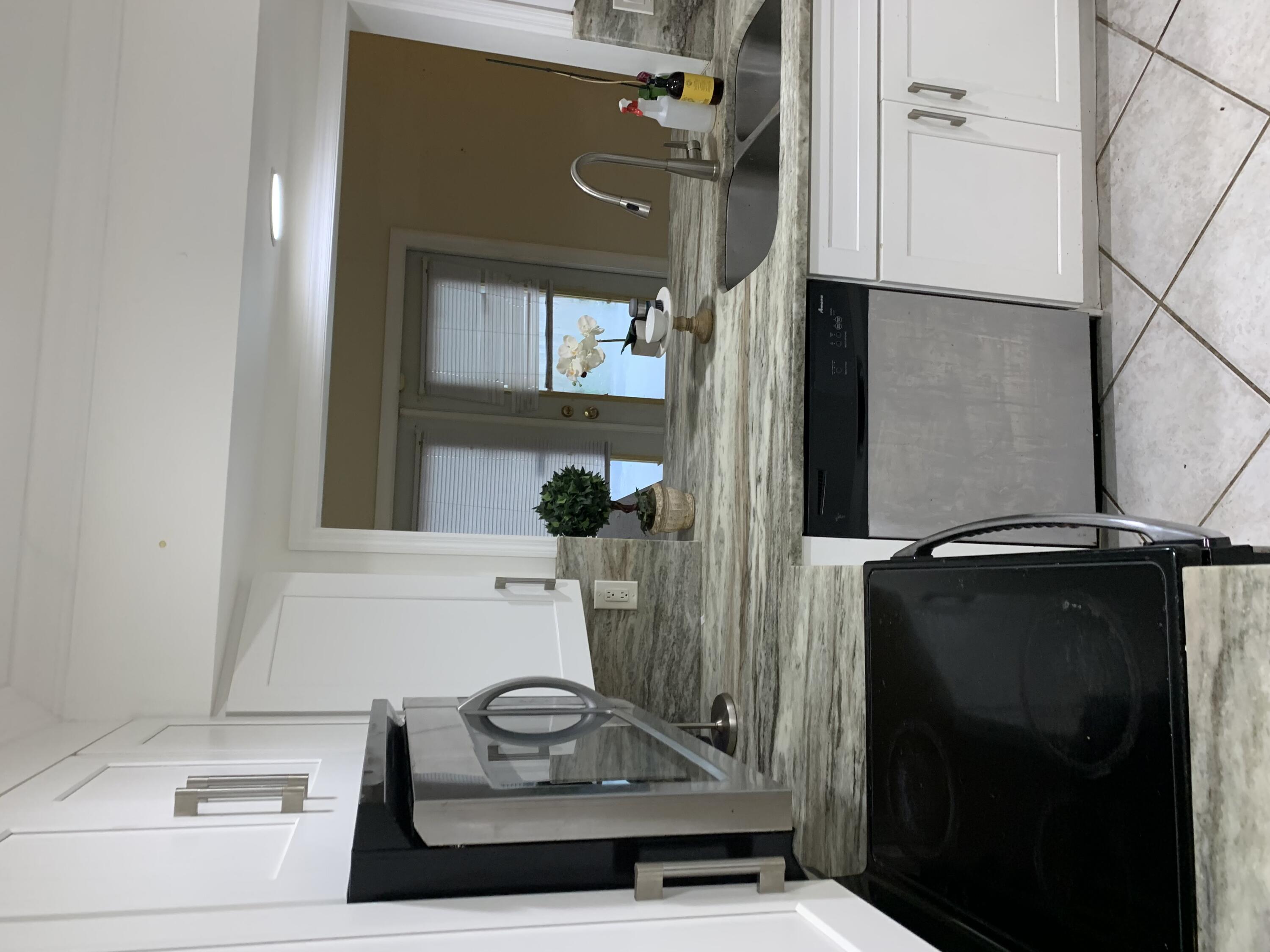 1156 Block Island Road Wellington, FL 33414 - Photo 9 of 15 a bathroom with a sink and a mirror