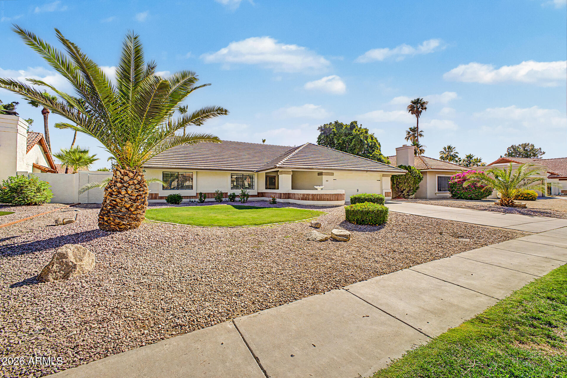 6725 West Utopia Road Glendale, AZ 85308 - Photo 2 of 27 a front view of a house with garden