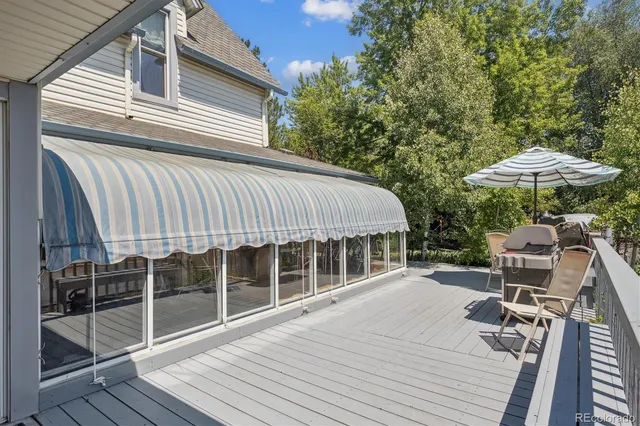 a balcony with table and chairs