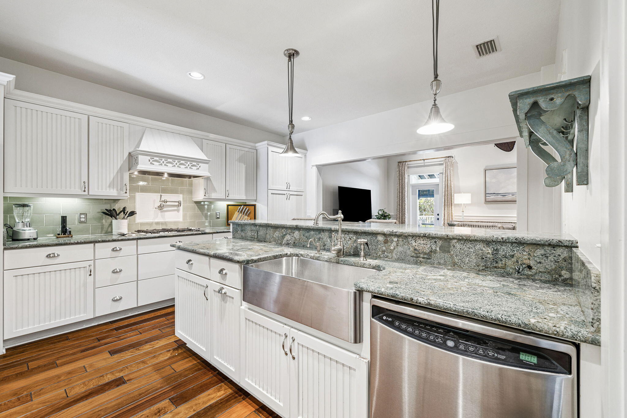 76 Crescent Road Santa Rosa Beach, FL 32459 - Photo 21 of 104 a kitchen with stainless steel appliances granite countertop a sink stove and white cabinets with wooden floor