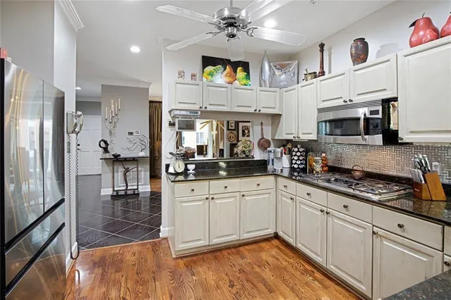 a metallic refrigerator freezer sitting in a kitchen