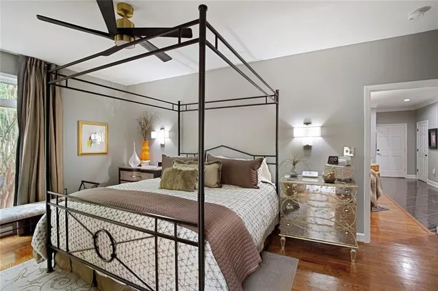 a spacious bathroom with a double vanity sink a large mirror a bathtub and next to a window