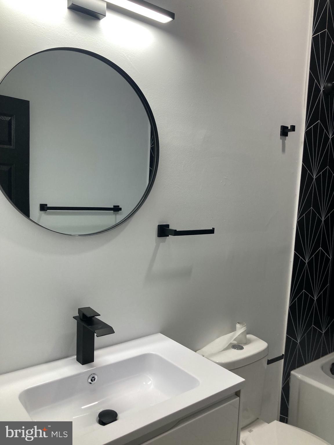 1830 West Diamond Street, Unit 1 Philadelphia, PA 19121 - Photo 11 of 17 a bathroom with a sink and a toilet