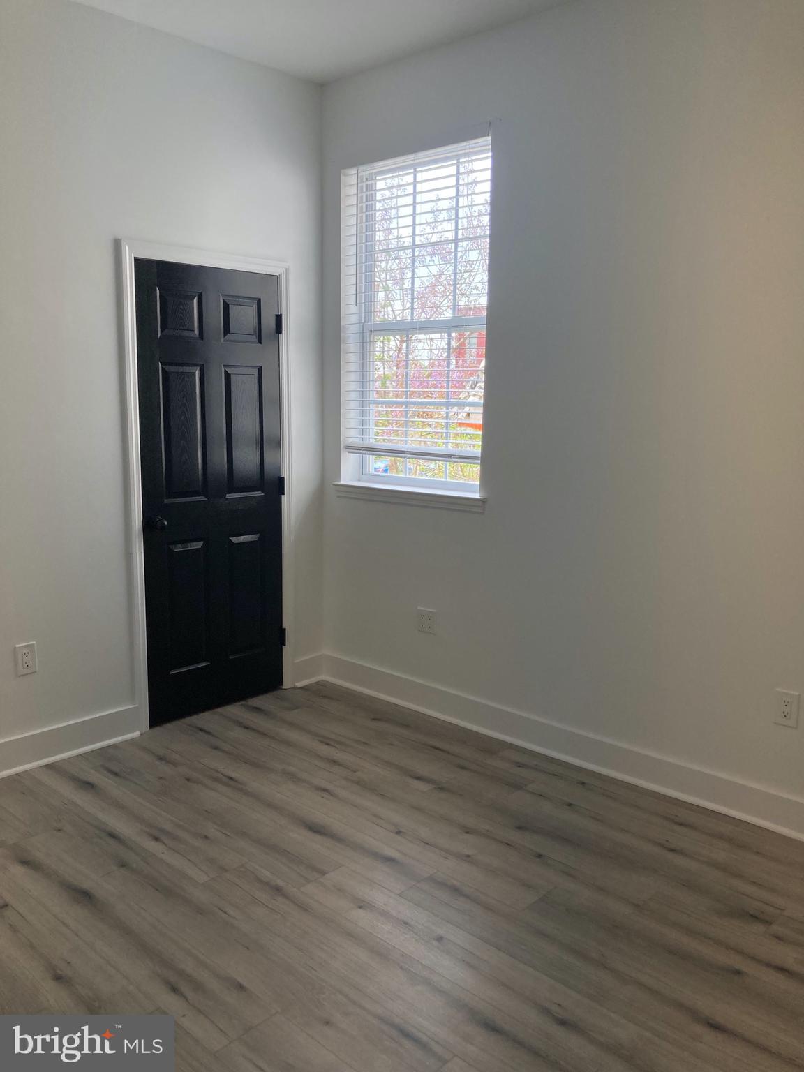1830 West Diamond Street, Unit 1 Philadelphia, PA 19121 - Photo 14 of 17 wooden floor and windows in an empty room