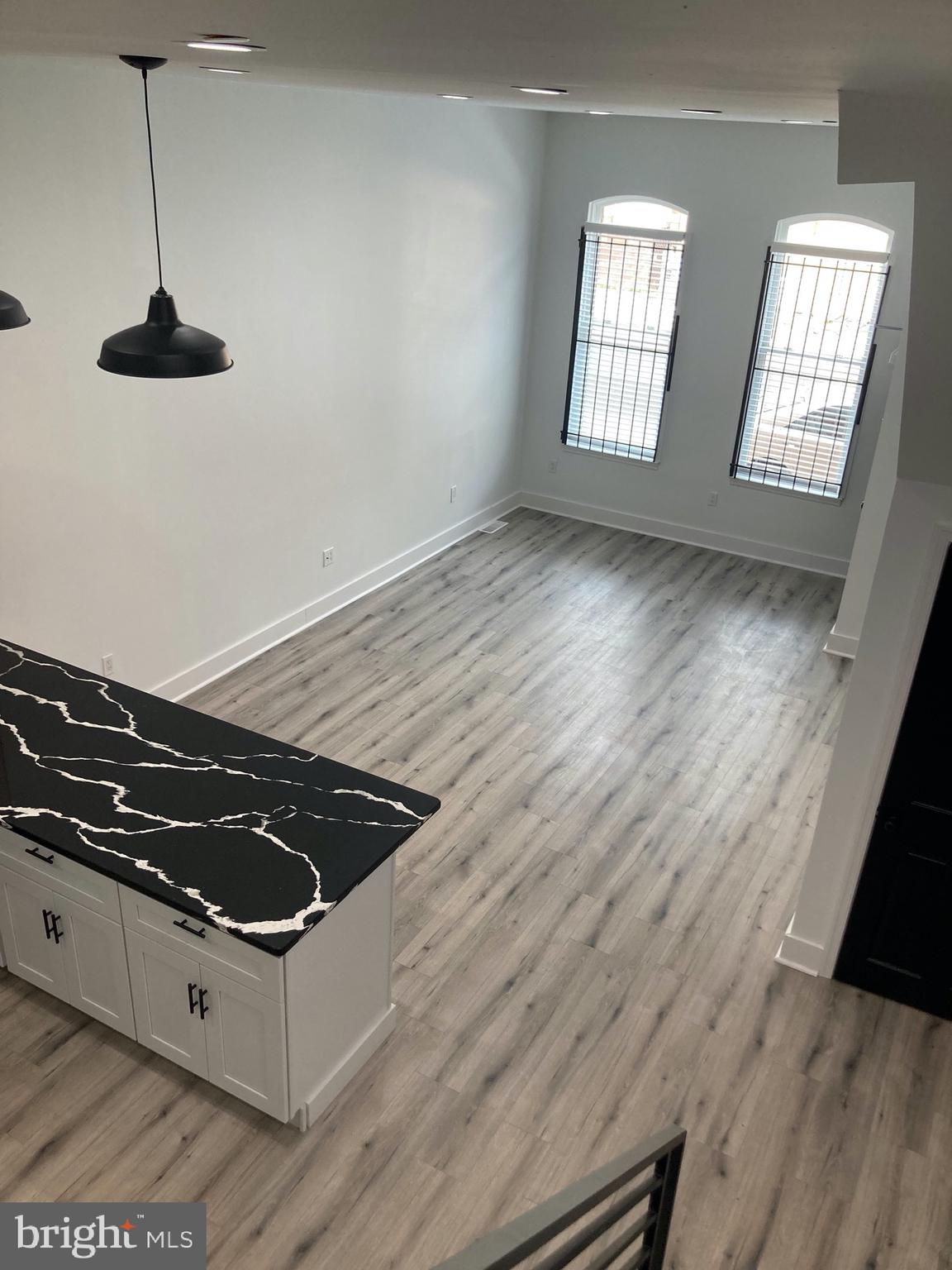 1830 West Diamond Street, Unit 1 Philadelphia, PA 19121 - Photo 5 of 17 a view of an empty room with wooden floor and a window