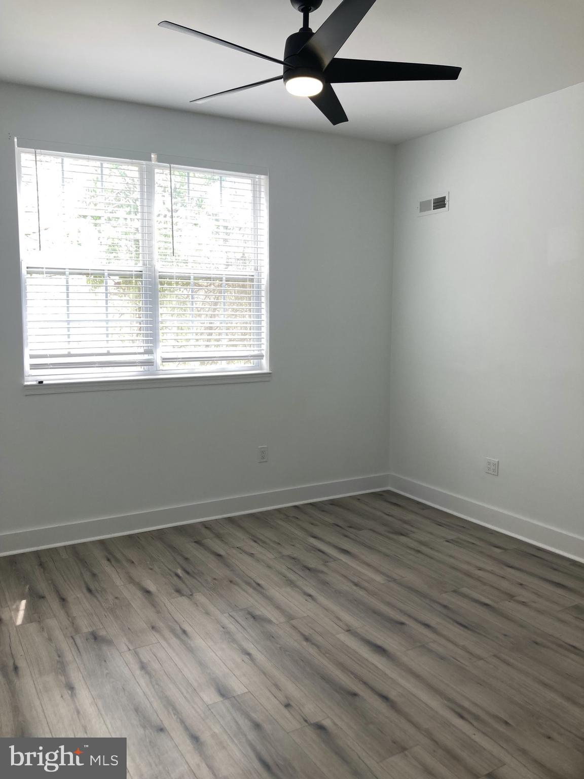 1830 West Diamond Street, Unit 1 Philadelphia, PA 19121 - Photo 6 of 17 an empty room with wooden floor and windows