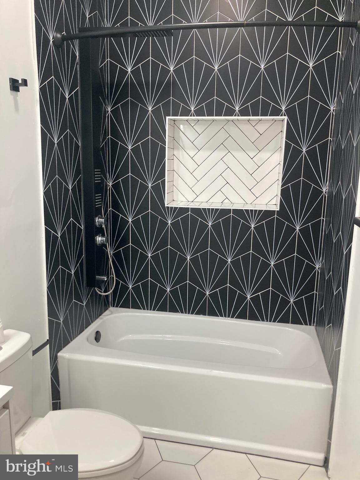 1830 West Diamond Street, Unit 1 Philadelphia, PA 19121 - Photo 7 of 17 a bathroom with a toilet and a bathtub