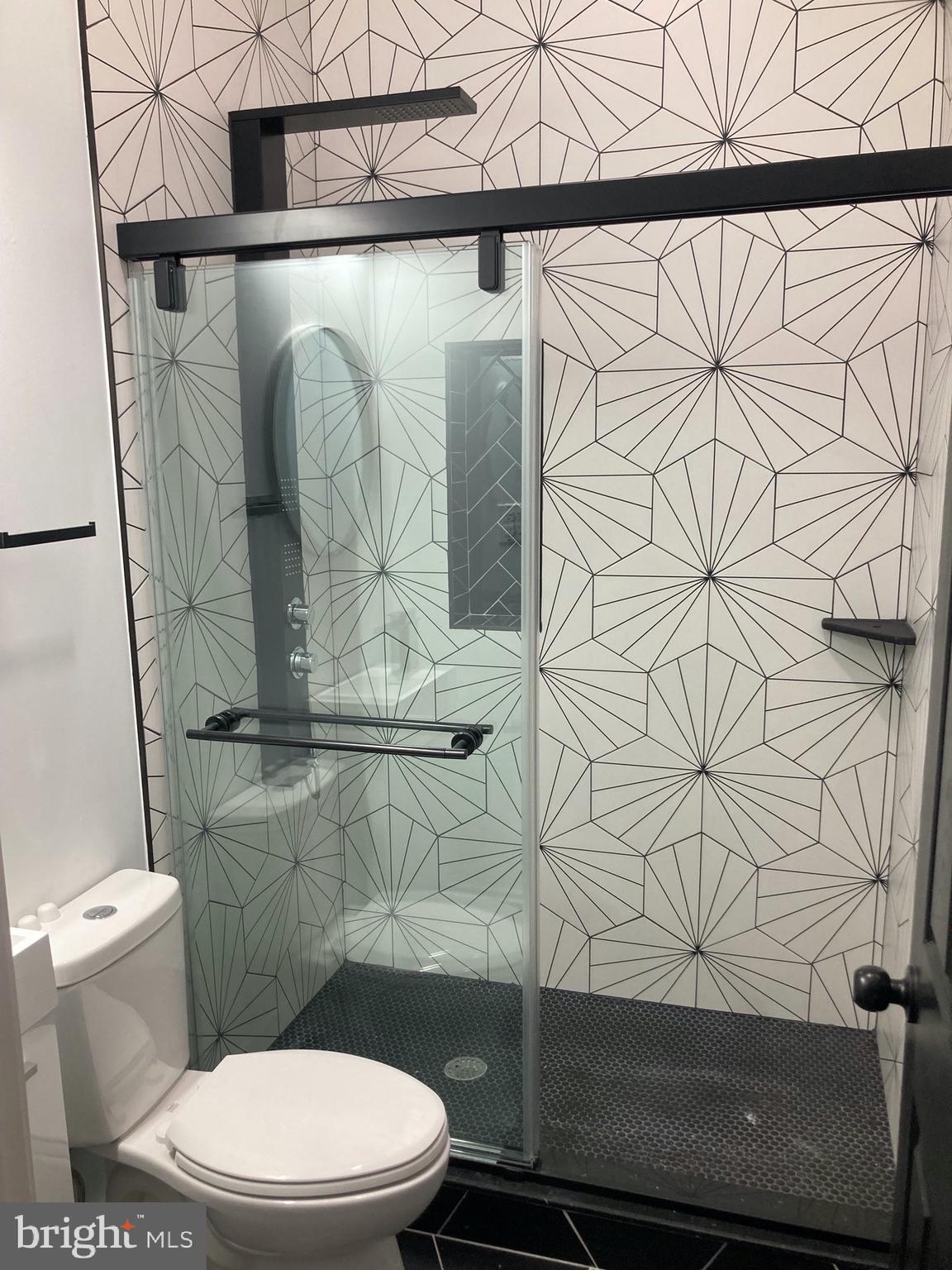 1830 West Diamond Street, Unit 1 Philadelphia, PA 19121 - Photo 8 of 17 a white toilet sitting next to a shower