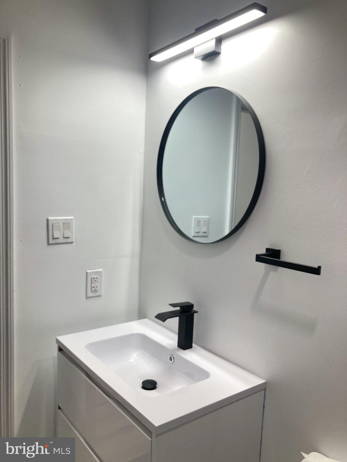 1830 West Diamond Street, Unit 1 Philadelphia, PA 19121 - Photo 10 of 17 a bathroom with a sink and a mirror