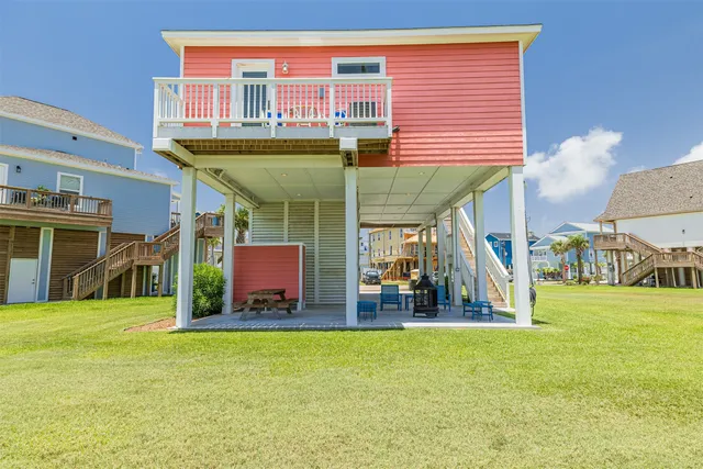 a view of a chairs and table in front of house