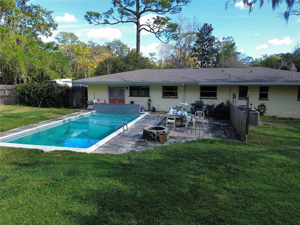 1324 Southeast 33rd Terrace Ocala, FL 34471 - Photo 6 of 6 a front view of a house with patio yard and outdoor seating