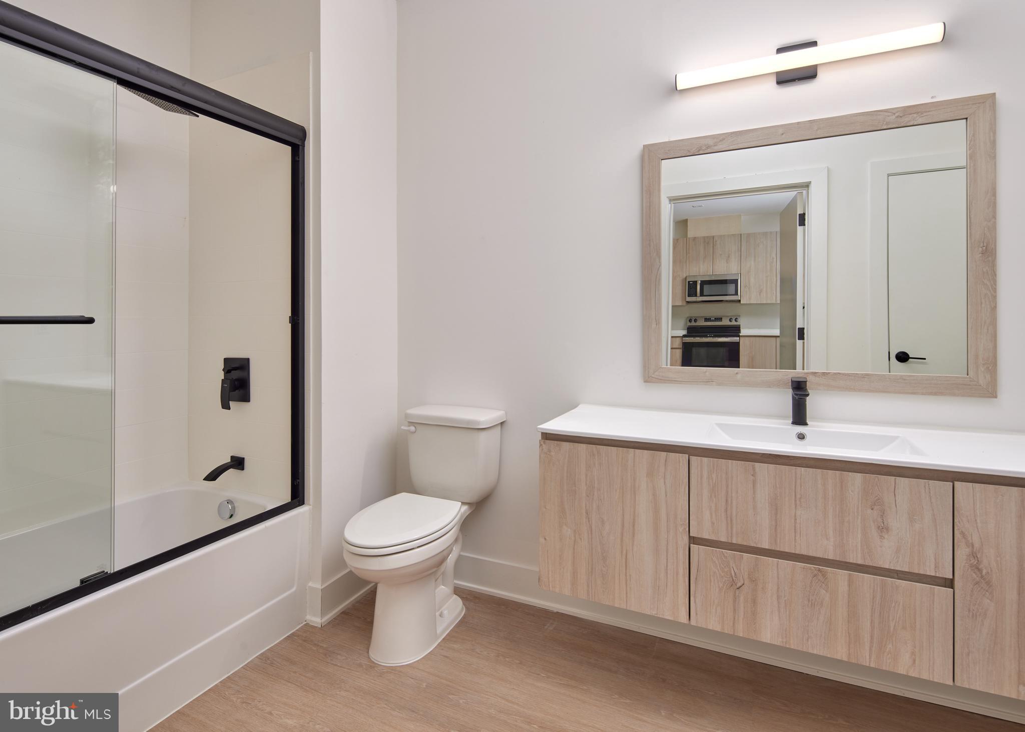 300 Furnace Street, Unit 303 Emmaus, PA 18049 - Photo 4 of 7 a bathroom with a toilet a sink and a mirror