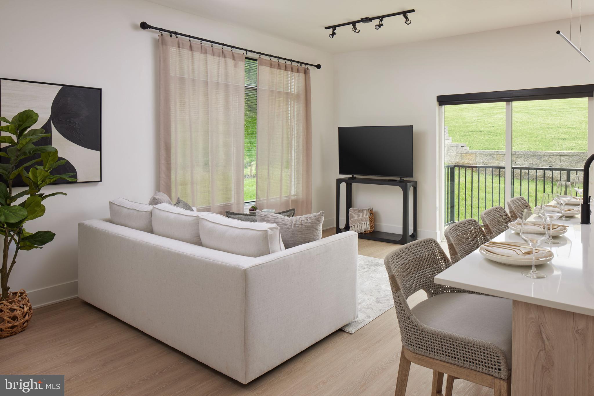 300 Furnace Street, Unit 303 Emmaus, PA 18049 - Photo 5 of 7 a living room with furniture and a flat screen tv