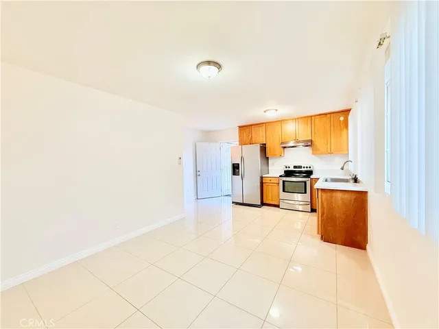 a kitchen with stainless steel appliances a refrigerator and cabinets