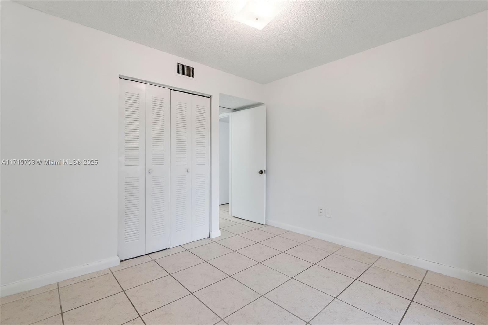 9729 Hammocks Boulevard, Unit 106E Miami, FL 33196 - Photo 11 of 25 a view of an empty room