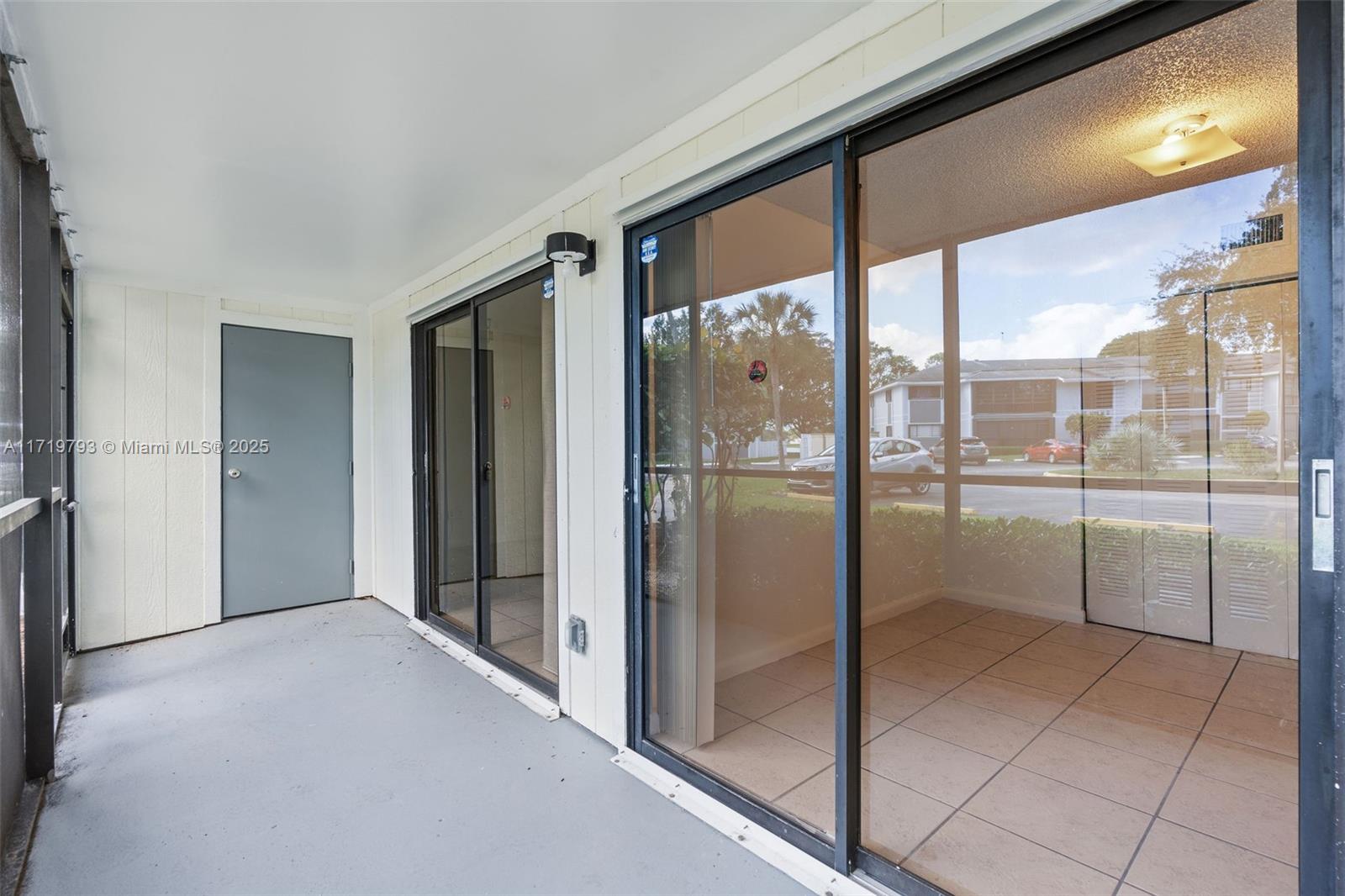 9729 Hammocks Boulevard, Unit 106E Miami, FL 33196 - Photo 23 of 25 a view of a hallway with a glass door