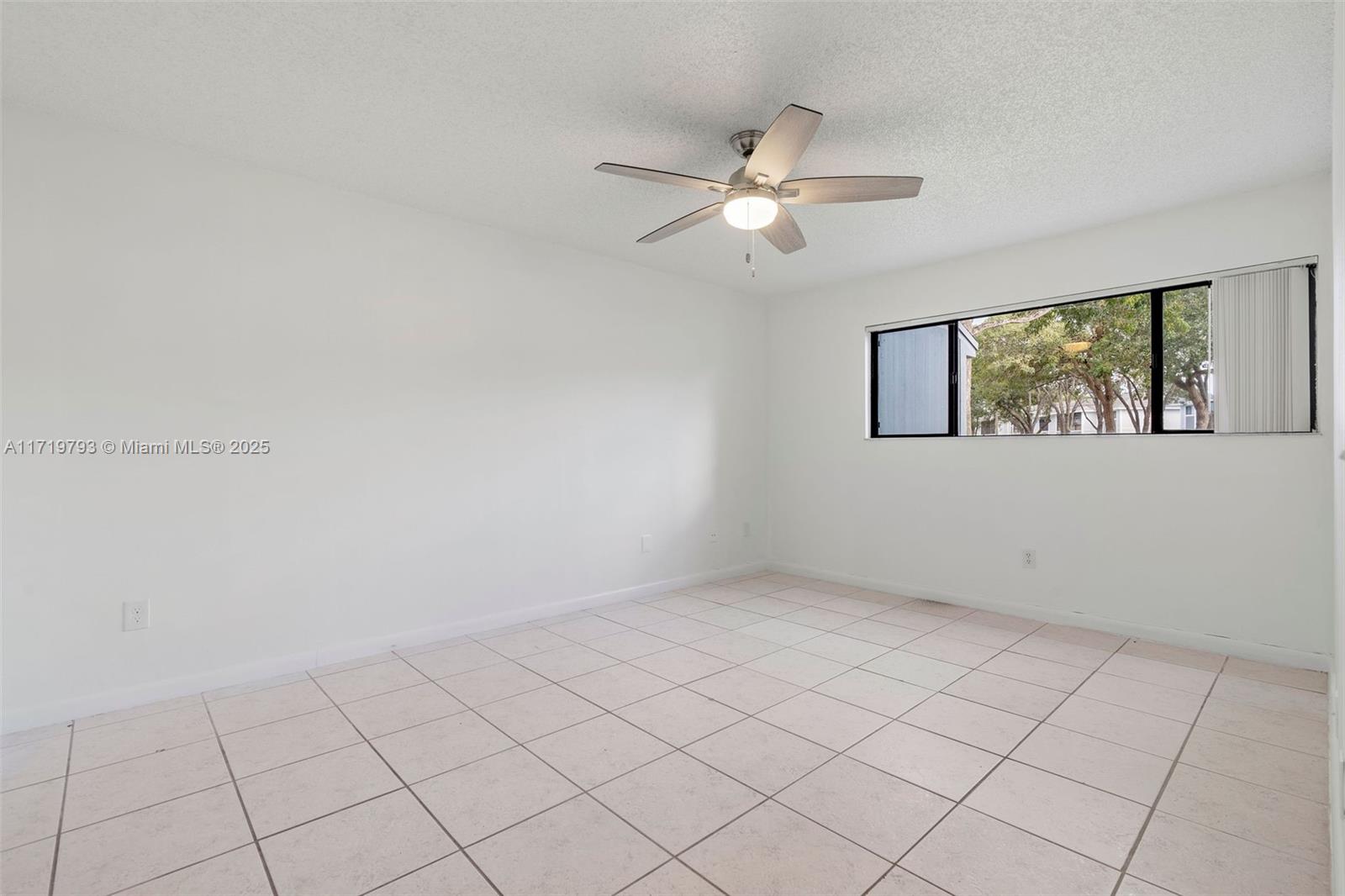 9729 Hammocks Boulevard, Unit 106E Miami, FL 33196 - Photo 6 of 25 a view of an empty room with a window