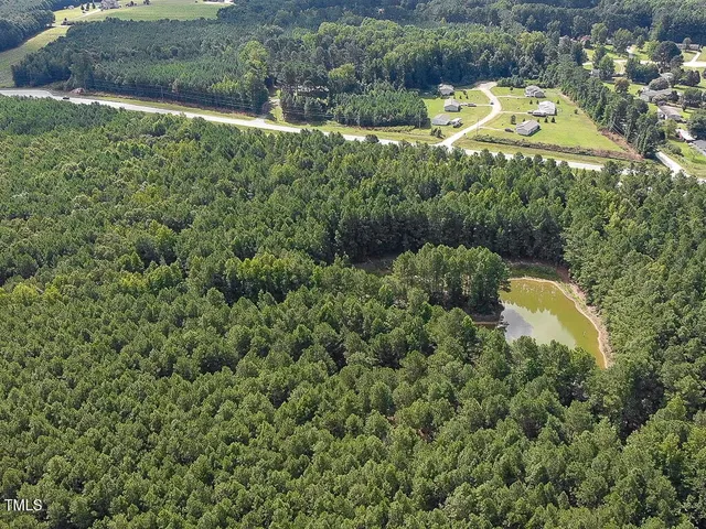an aerial view of a house with a yard and lake view
