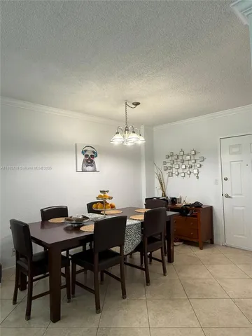 a dining room with a table and chairs