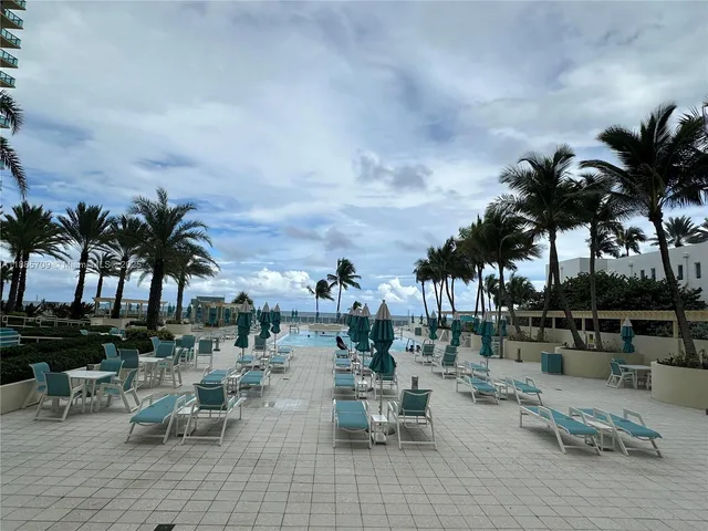 an outdoor space with patio swimming pool and outdoor seating