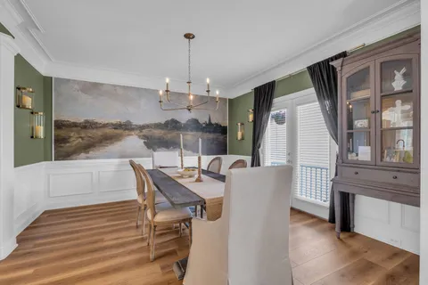 a view of a dining room with furniture window and wooden floor