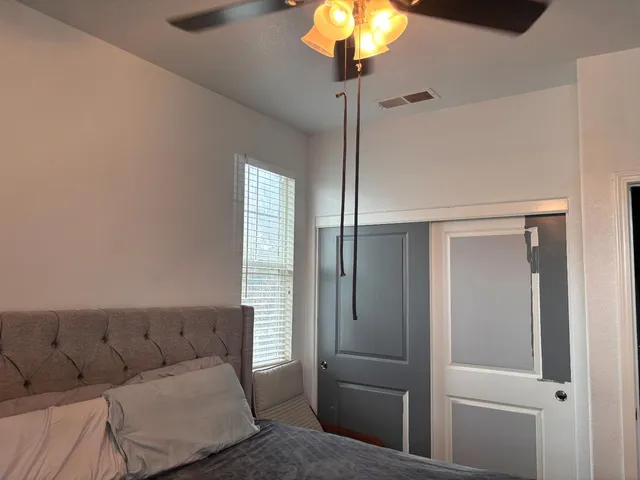 a bedroom with a bed and a flat screen tv