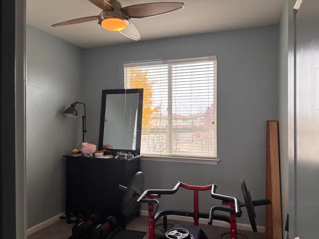 a view of a workspace with furniture and a window