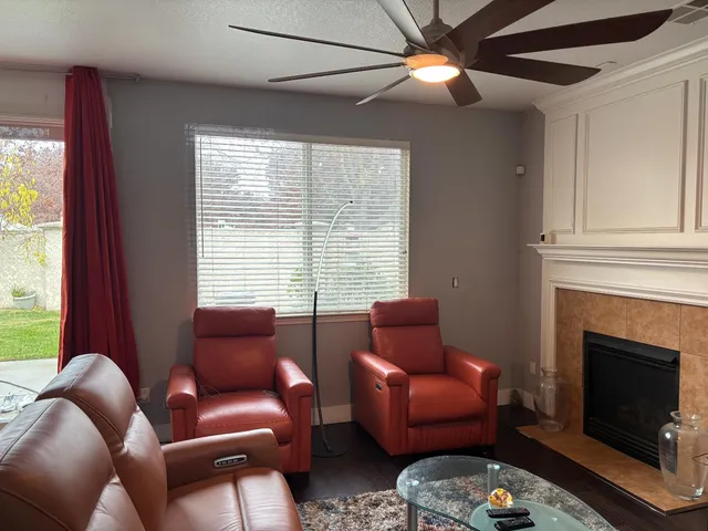 a living room with furniture a fireplace and a window