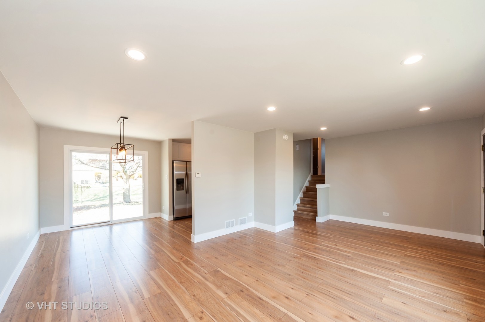 608 Willow Road Matteson, IL 60443 - Photo 3 of 15 an empty room with wooden floor and windows