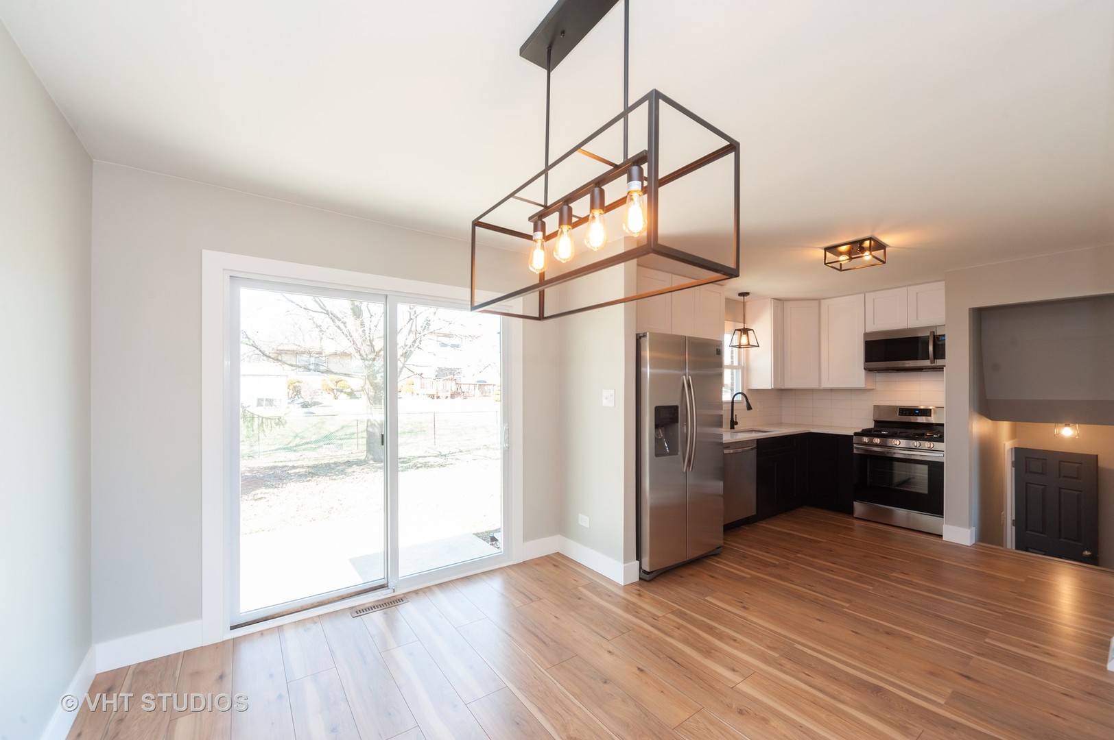 608 Willow Road Matteson, IL 60443 - Photo 5 of 15 a kitchen with stainless steel appliances granite countertop a refrigerator a sink dishwasher a stove and white countertops with wooden floor