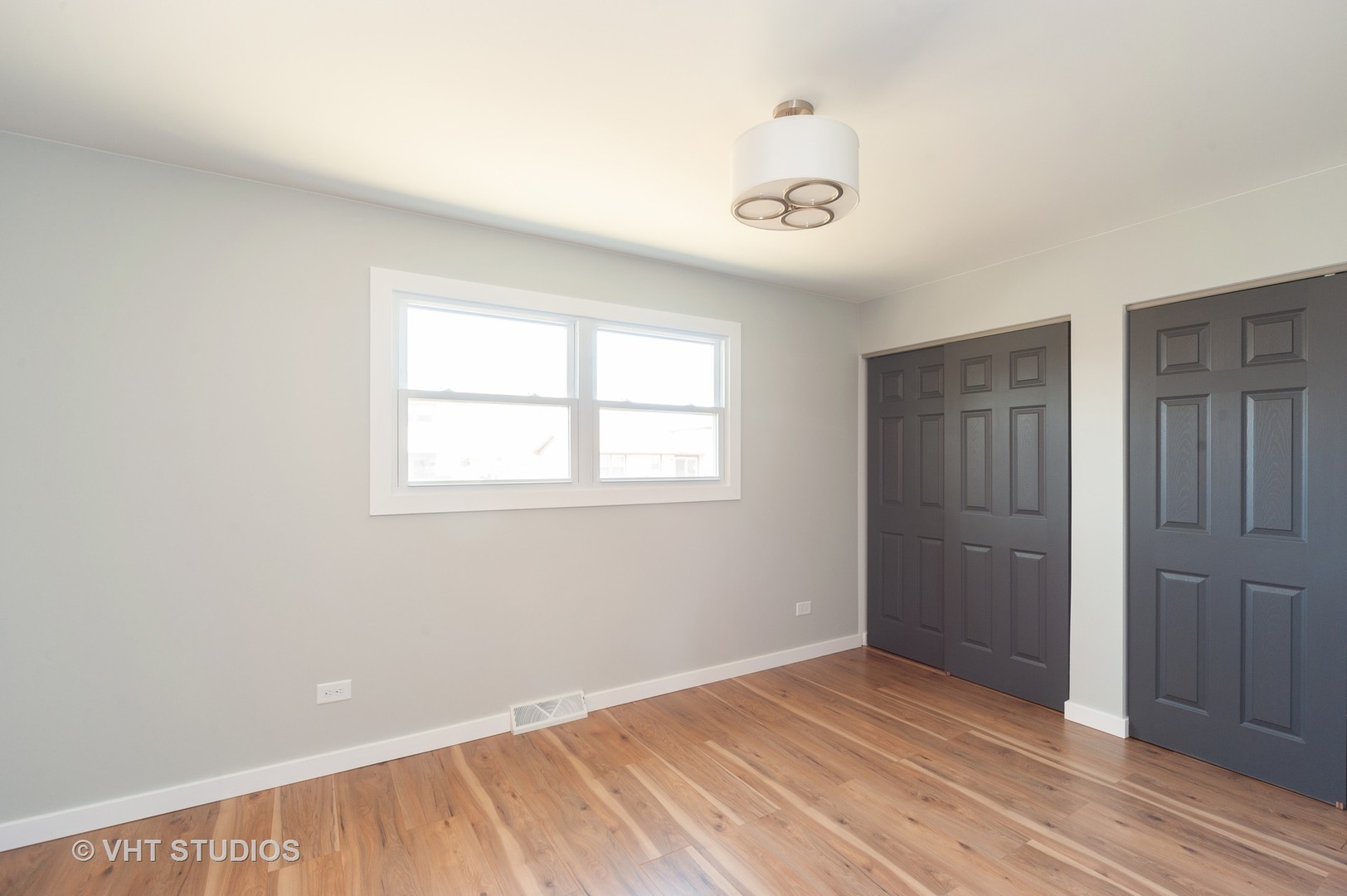608 Willow Road Matteson, IL 60443 - Photo 8 of 15 an empty room with wooden floor and windows
